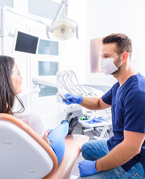 Periodontist discuss dental implant restoration with patient