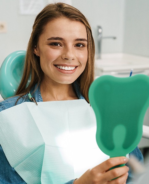 Woman with dental implants in Dallas TX in dentist’s office