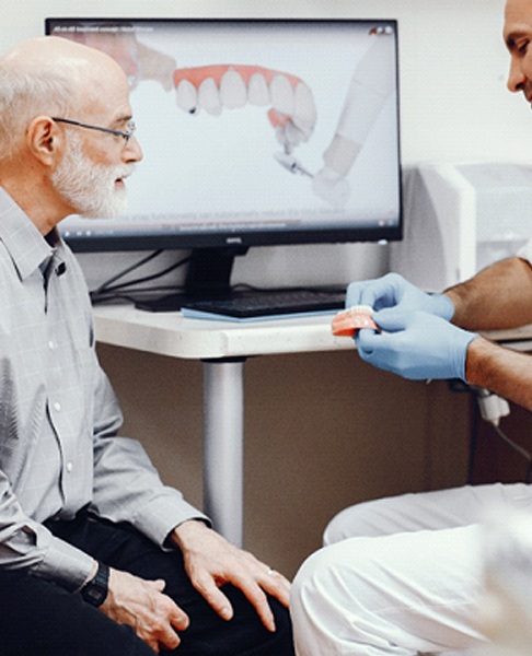 Dentist and older man discussing candidacy for All-on-4