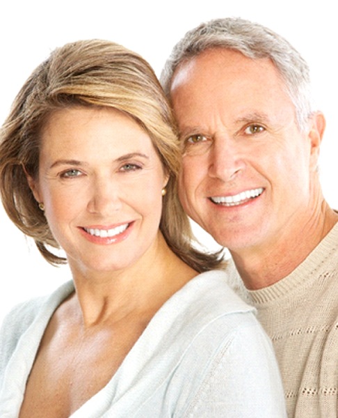 Happy senior couple enjoying benefits of All-on-4 dentures