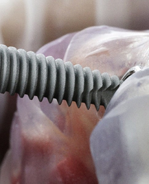 Close-up of dental implant being inserted into jawbone model