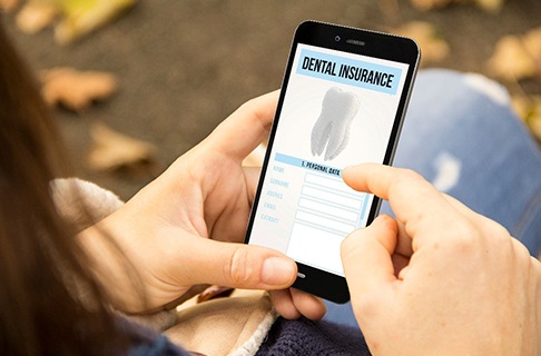 A dentist discussing dental insurance with her patients