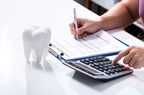 An adult man paying the cost of a tooth extractions