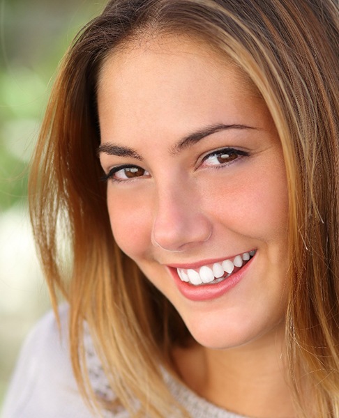 Smiling woman, enjoying the benefits of gum recontouring in Dallas
