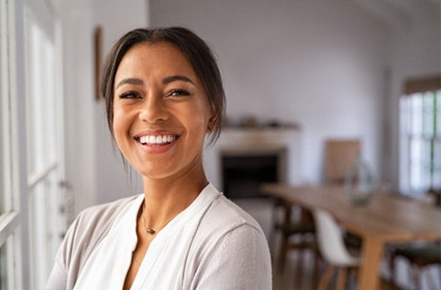 Woman at home with dental implants in Dallas, TX