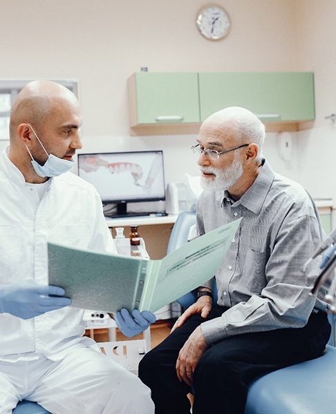 Senior man learning about his candidacy for dental implants