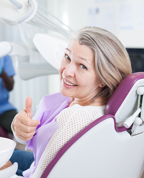 woman smiling after getting dental implants in Dallas