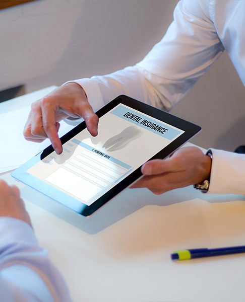 Person pointing at dental insurance forms on tablet