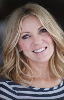 Blonde woman with striped shirt smiling