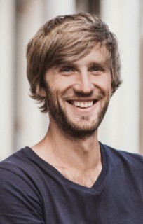 Close-up of man in grey shirt smiling