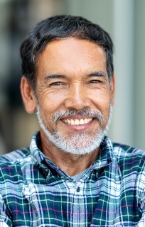 Bearded man standing and smiling