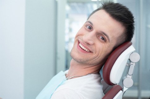 Male periodontal patient looking to side and smiling