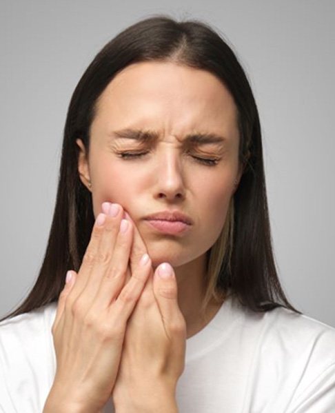 Young woman suffering from mouth pain