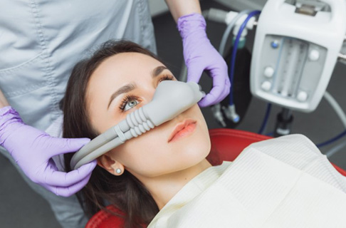 Placing nasal mask on woman's nose