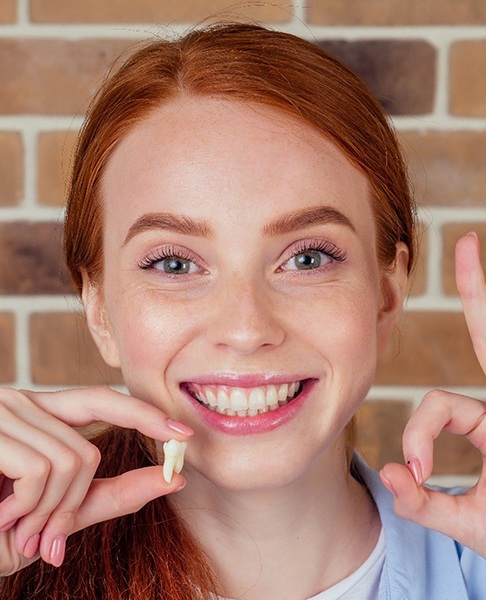 Woman making OK sign after wisdom tooth extractions