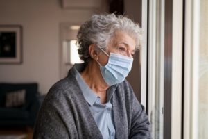 Woman wearing mask, concerned about gum disease in Dallas