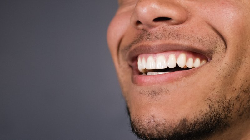 Man smiling after receiving crown lengthening treatment